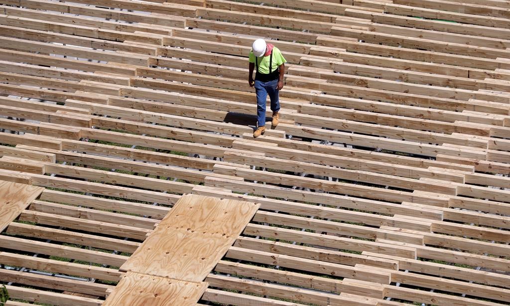 FILE - In this April 9, 2019, file photo a worker walks along the a structure being built. (AP Photo/Mark Humphrey, File)